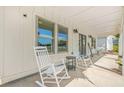 Covered front porch with rocking chairs perfect for relaxing and enjoying the view at 20 Tuscany Dr, Mansfield, GA 30055