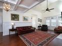 Bright living room features a coffered ceiling, hardwood floors, large windows, and ample seating at 4845 Josie Way, Acworth, GA 30101