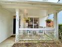 Inviting front porch featuring white railing, comfortable seating, and hanging floral arrangements at 2168 Berryhill Se Cir, Smyrna, GA 30082