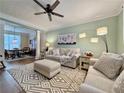 Cozy living room with a modern ceiling fan, plush sofas, decorative rug, and plenty of natural light at 2168 Berryhill Se Cir, Smyrna, GA 30082