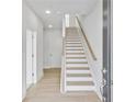 Bright entryway featuring hardwood floors and a staircase with modern wood and white accents at 2637 Camphor Se Xing # 83, Smyrna, GA 30080