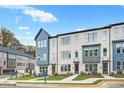 Attractive townhomes with a modern design, lush lawns, and inviting walkways on a sunny day at 2637 Camphor Se Xing # 83, Smyrna, GA 30080