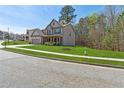 Manicured lawn with a two-story home featuring a convenient two car garage and inviting facade at 2096 Hamilton Lake Pkwy, Buford, GA 30519