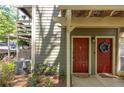 Charming condo entrance with well-maintained landscaping and red front doors at 606 Se Riverview Dr # 606, Marietta, GA 30067