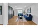 Bright living room with hardwood floors, modern decor, and a stylish accent wall at 814 Bank St, Smyrna, GA 30080