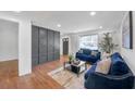 Cozy living room featuring hardwood floors, a statement wall, and ample natural light from a large window at 814 Bank St, Smyrna, GA 30080