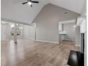 Open living room featuring wood floors, high ceilings, and a fireplace at 4625 Thermal Ct, Douglasville, GA 30135