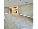 Open concept living room and kitchen area with herringbone tiled flooring and recessed lighting throughout at 6123 Deerfield Ct, Morrow, GA 30260