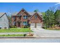 Lovely two story brick home with attached garage and front yard at 6802 Potomac, Fairburn, GA 30213