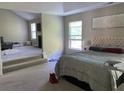 Spacious main bedroom with a seating area, carpet, and plenty of light at 6802 Potomac, Fairburn, GA 30213