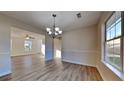 Bright dining area with wood floors and a view of the living room at 6808 Foxfire Pl, South Fulton, GA 30349