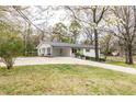 Charming single-story home with a carport and a bright green front door, situated on a well-maintained property at 3888 W Oak Dr, Douglasville, GA 30135