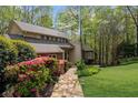 Landscaped front yard with stone walkway leading to the home, framed by lush greenery and mature trees at 420 Longs Peak, Johns Creek, GA 30022