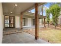 Covered porch boasts natural wood columns and gray tile flooring at 5361 Seaton Way, Dunwoody, GA 30338