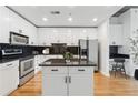 Contemporary kitchen featuring white cabinets, black countertops, and stainless steel appliances at 860 Peachtree Ne St # 2503, Atlanta, GA 30308