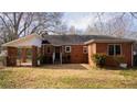 The back exterior of a brick home showing a covered carport and large yard at 1751 Tiger Flowers Nw Dr, Atlanta, GA 30314
