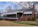 Close up of a classic brick home with screened in porch at 1751 Tiger Flowers Nw Dr, Atlanta, GA 30314