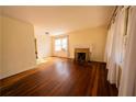 Inviting living room featuring beautiful hardwood floors and a brick fireplace at 1751 Tiger Flowers Nw Dr, Atlanta, GA 30314