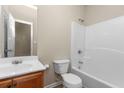Standard bathroom featuring a wood vanity, single sink, toilet, and shower-tub combination at 201 Creel Way, Atlanta, GA 30349