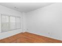 Bright bedroom featuring hardwood floors, a large window with blinds and neutral paint at 201 Creel Way, Atlanta, GA 30349