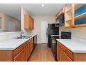 Functional kitchen with wood cabinets, black appliances, and laminate countertops at 201 Creel Way, Atlanta, GA 30349