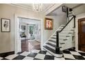 Elegant foyer features a staircase, checkerboard flooring, and living room view at 2628 Rivers Nw Rd, Atlanta, GA 30305
