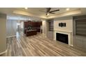 Spacious open-concept living room featuring hardwood floors, fireplace, and built-in shelving at 2460 Laurel Gate Ln, Cumming, GA 30040