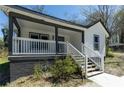 Welcoming covered front porch with white railings and fresh paint details at 665 S Eugenia Nw Pl, Atlanta, GA 30318
