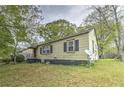 Charming one-story home featuring a simple design and surrounded by mature trees at 3540 Victoria St, Atlanta, GA 30337