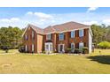 Attractive brick home with well-kept lawn and mature landscaping at 859 Pownal Ln, Hampton, GA 30228