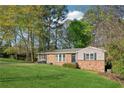 Lovely brick house with a lush front yard and mature trees offering shade and privacy in a quiet neighborhood at 2434 Skyland Ne Trl, Brookhaven, GA 30319