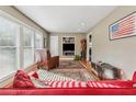 Bright living area with large windows, hardwood floors, and a cozy armchair, perfect for relaxing and entertaining guests at 2434 Skyland Ne Trl, Brookhaven, GA 30319