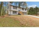 Charming two-story home with a wide driveway leading to a two-car garage and a yard awaiting landscape at 5331 Woodbin Dr, Norcross, GA 30093
