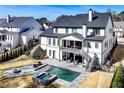 Aerial view showcases a luxurious backyard with pool, spa, fire pit, patio, and elegant landscaping, great for entertaining at 109 Owens Mill Pl, Canton, GA 30115