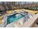 Aerial view of the backyard featuring a stunning pool, spa, firepit, and well-maintained lawn, ideal for outdoor enjoyment at 109 Owens Mill Pl, Canton, GA 30115