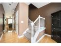 Inviting home entryway with hardwood floors, neutral paint, staircase, and closet, leading into a cozy living space at 4743 Longcourt Se Dr, Atlanta, GA 30339
