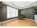 Comfortable living room with large window for natural light, hardwood floors, and built-in shelving with modern decor at 4743 Longcourt Se Dr, Atlanta, GA 30339
