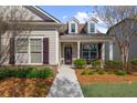 Cozy covered porch with decorative pillars, stone accents, and a well maintained lawn at 722 Laurel Canyon Pkwy, Canton, GA 30114