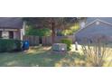 Fenced backyard with lush greenery, shrubs, and trees for privacy and outdoor enjoyment at 8219 Canyon Forge Dr, Riverdale, GA 30274