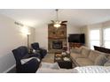 Cozy living room features a stone fireplace, vaulted ceiling, comfortable seating, and natural light at 2562 Kennesaw Springs Nw Ct, Kennesaw, GA 30144