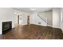 Open-concept living room with stairs and wood-look tile flooring throughout at 2970 Aspen Woods Entry, Atlanta, GA 30360