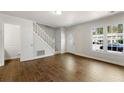 Bright living room with stairs, white trim and wood-look tile floors at 2970 Aspen Woods Entry, Atlanta, GA 30360