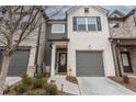 Charming two-story home with gray and white brick exterior, a garage, and a well-kept front yard at 3132 Meadowstone Sw Ln, Atlanta, GA 30331