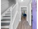 Inviting entryway featuring staircase, modern flooring, and light, neutral paint at 5005 Pat Mell Se Pl, Smyrna, GA 30080