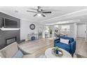 Cozy living room with fireplace, ceiling fan, and open floor plan at 5005 Pat Mell Se Pl, Smyrna, GA 30080