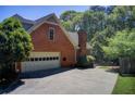 A two car garage with brick exterior and a driveway at 5162 Charlemagne Sw Way, Lilburn, GA 30047