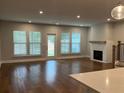 Bright living room features hardwood floors, fireplace, and lots of natural light at 138 Briargate Dr, Johns Creek, GA 30097