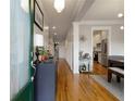 Inviting home hallway featuring hardwood floors, stylish decor, and access to the kitchen at 1814 Dupont Nw Ave, Atlanta, GA 30318