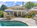 Inviting backyard with pool, patio area, outdoor kitchen, lush greenery, perfect for entertaining and relaxation at 2314 Edgemere Lake Cir, Marietta, GA 30062