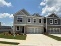 Charming two-story home with a brick and gray exterior, a two car garage, and an inviting, landscaped front yard at 315 Lakeside Ct, Canton, GA 30114